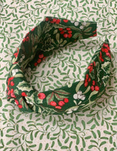 Christmas Mistletoe and Holly cotton printed Knotted headband, Green base colour, with oviry and green foliage and white and red berries. A perfect addition to your festive wardrobe.