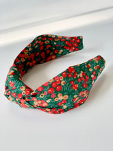 Knotted headband in a festive Liberty print called Wiltshire, in colours green, red and gold. very festive.