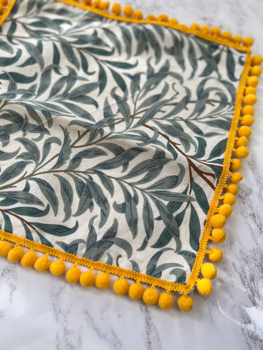 William Morris Table napkins with contrast pom pom trimming, here Green and ivory colour with a Mustard gold Pom Pom trimming 